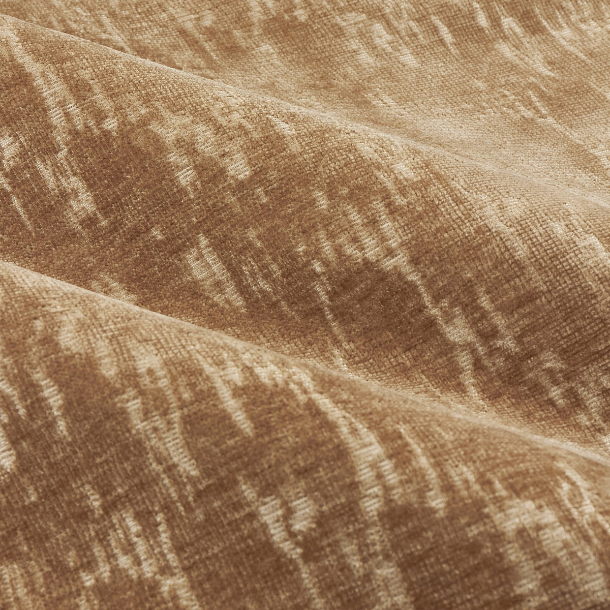 Close-up of Aurelio Chenille Jacquard eyelet curtain fabric in caramel, showing soft draped folds with a mottled gold-toned abstract texture.
