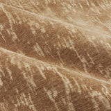 Close-up of Aurelio Chenille Jacquard eyelet curtain fabric in caramel, showing soft draped folds with a mottled gold-toned abstract texture.