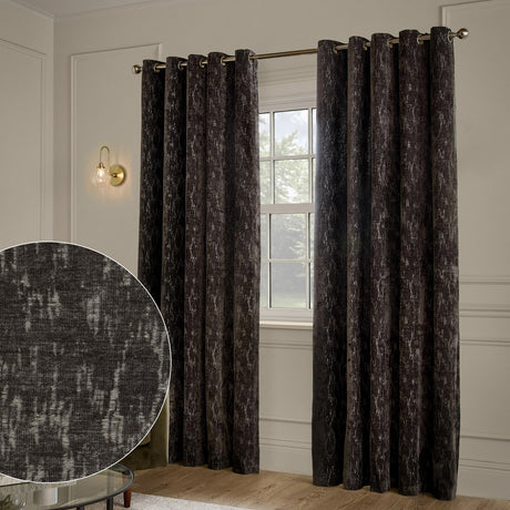 Aurelio Chenille Jacquard Fully Lined Eyelet Curtains in charcoal, hung on a metal pole in a living room, showing a textured abstract weave with pale flecks, with a fabric swatch inset.