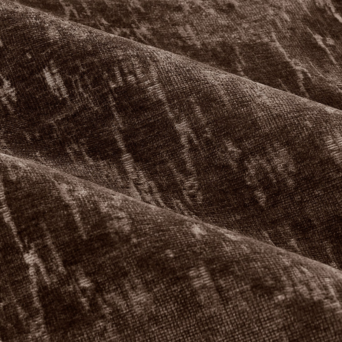 Close-up of the Aurelio chenille jacquard eyelet curtain fabric in chocolate brown, showing soft folds and a subtle abstract woven texture.