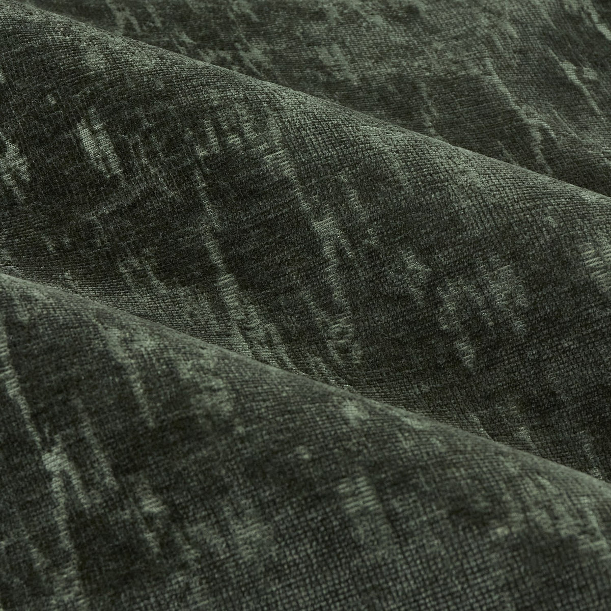 Close-up of Aurelio Chenille Jacquard eyelet curtain fabric in emerald, showing soft draped folds with a subtle textured jacquard pattern.