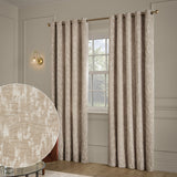 Aurelio Chenille Jacquard Fully Lined Eyelet Curtains in mink, shown as a pair with brass eyelet rings and rod, hung at a living room window with a fabric texture swatch inset.