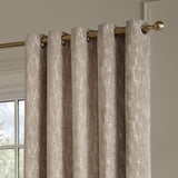 Aurelio Chenille Jacquard Eyelet Curtains in mink, fully lined with metal eyelets on a brass curtain pole, showing a subtle textured pattern in a living room setting.