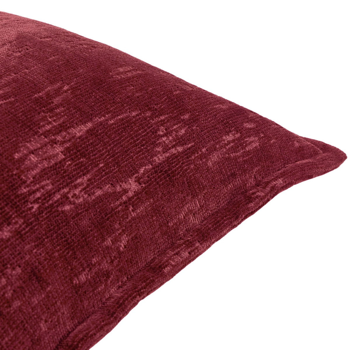 Close-up of the Aurelio Chenille Jacquard Polyester Cushion in burgundy, showing a soft dense pile with a mottled abstract woven texture and piped edge, on a white background.