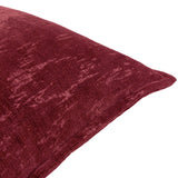 Close-up of the Aurelio Chenille Jacquard Polyester Cushion in burgundy, showing a soft dense pile with a mottled abstract woven texture and piped edge, on a white background.