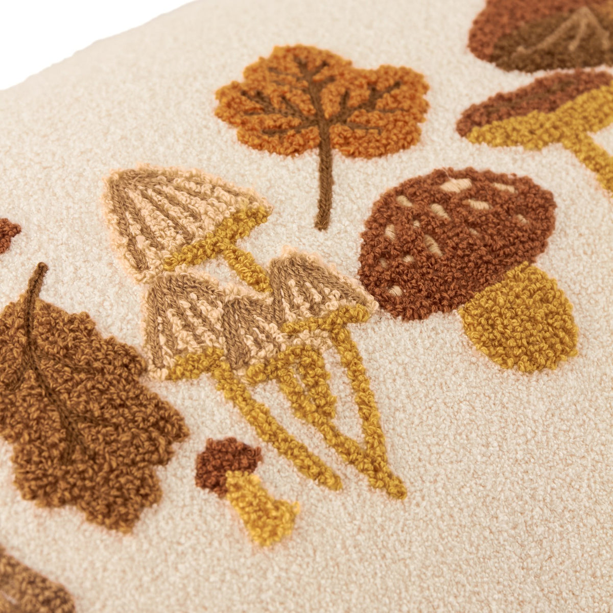 Close-up of the Autumn Forage Woodland cushion in Truffle, showing tufted mushrooms and embroidered autumn leaves in brown, amber and mustard on a cream polyester ground.