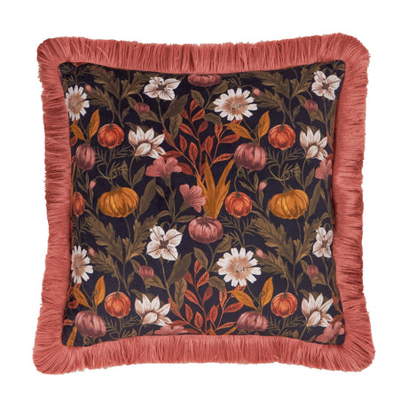 Square velvet cushion with an autumn floral and pumpkin print in rust, orange, gold, cream and moss green on black, edged with a burnished rose fringe trim.