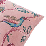 Aviary Velvet Cotton Cushion in Blushed Rose, close-up on blush pink cotton velvet with a printed bird and floral branch design in green, teal and deep red tones, shown on a white background.