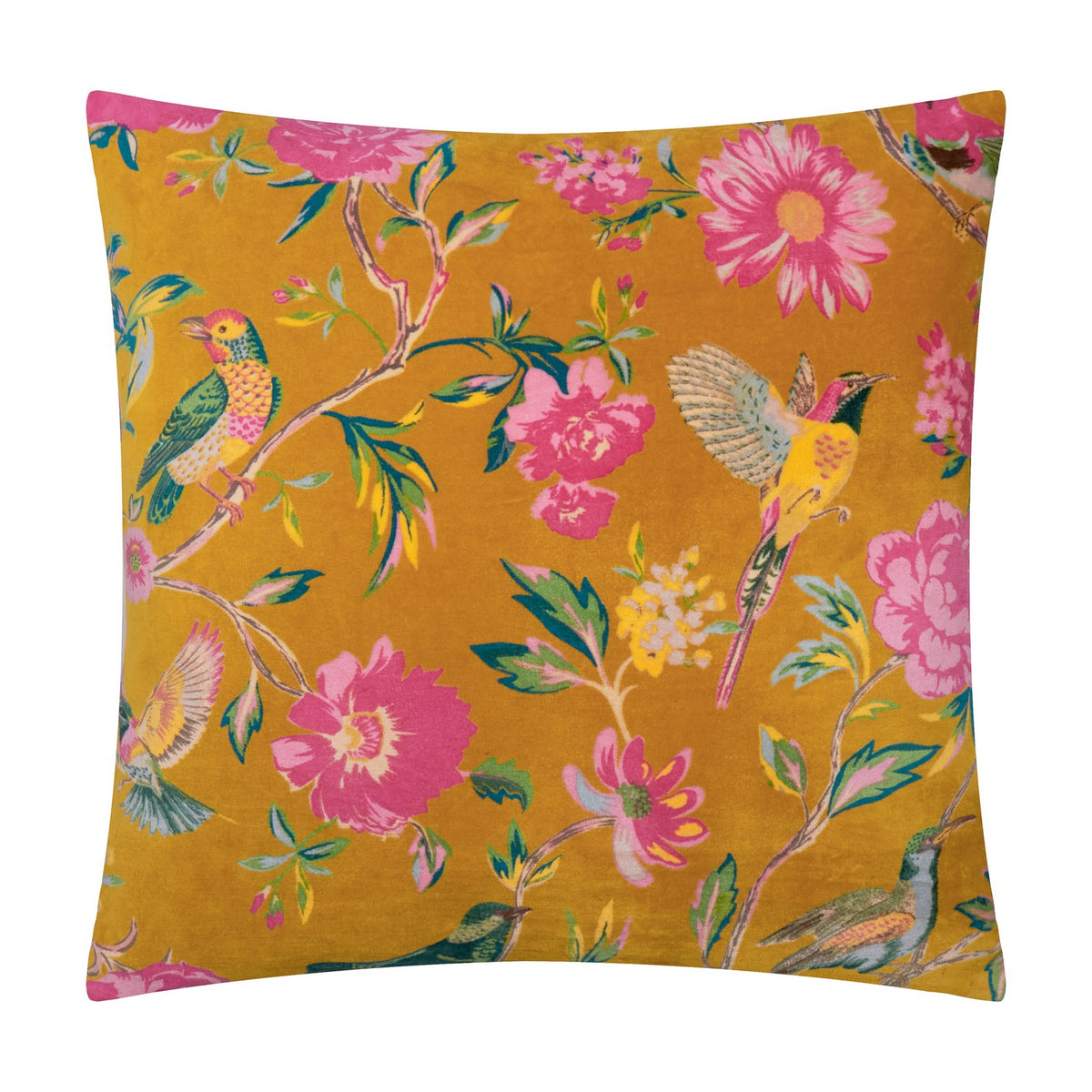 Aviary Velvet Cotton Cushion in gold, a square scatter cushion printed with pink peonies, daisies and perching birds on foliage, shown against a plain white background.