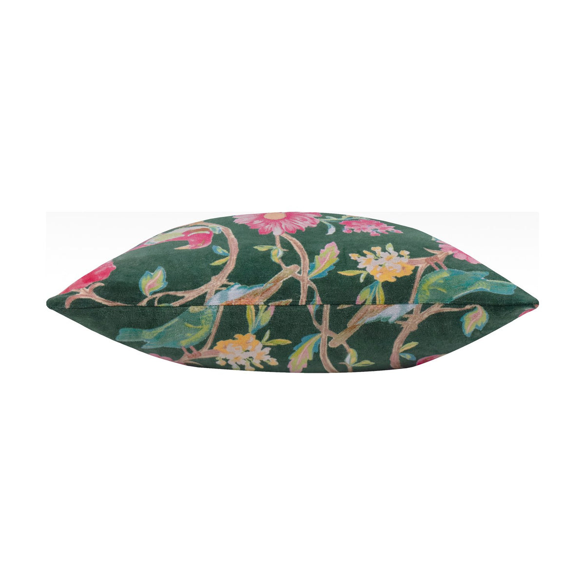 Aviary Velvet Cotton Cushion in teal green, shown edge-on to highlight its plump shape, with pink, yellow, and cream floral print on cotton velvet against a plain white background.
