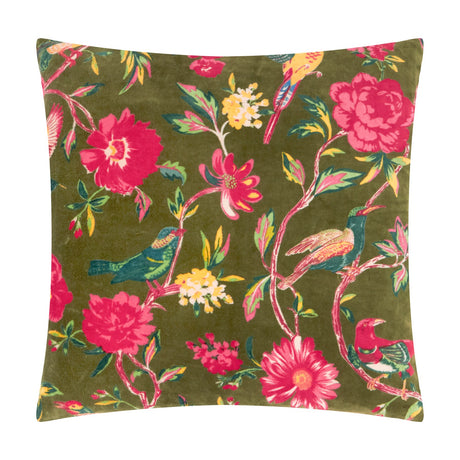 Square Aviary velvet cotton cushion in Woodgrove Green, printed with pink peonies, yellow blooms and teal-orange birds among foliage, shown on a white background.
