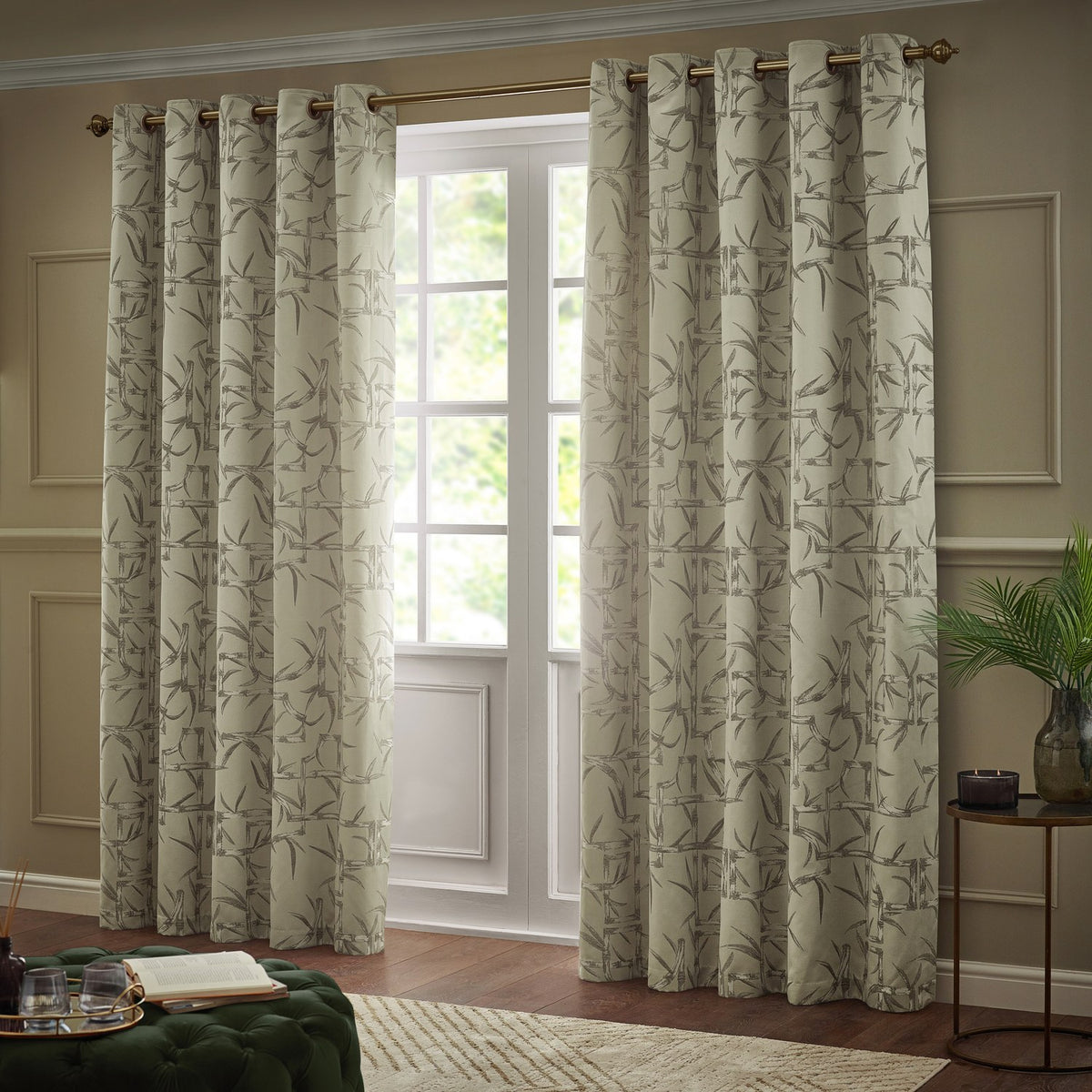 Bamboo Jacquard Lined Eyelet Curtains in champagne with grey bamboo pattern, hung on a bronze pole beside a French door in a living room setting.