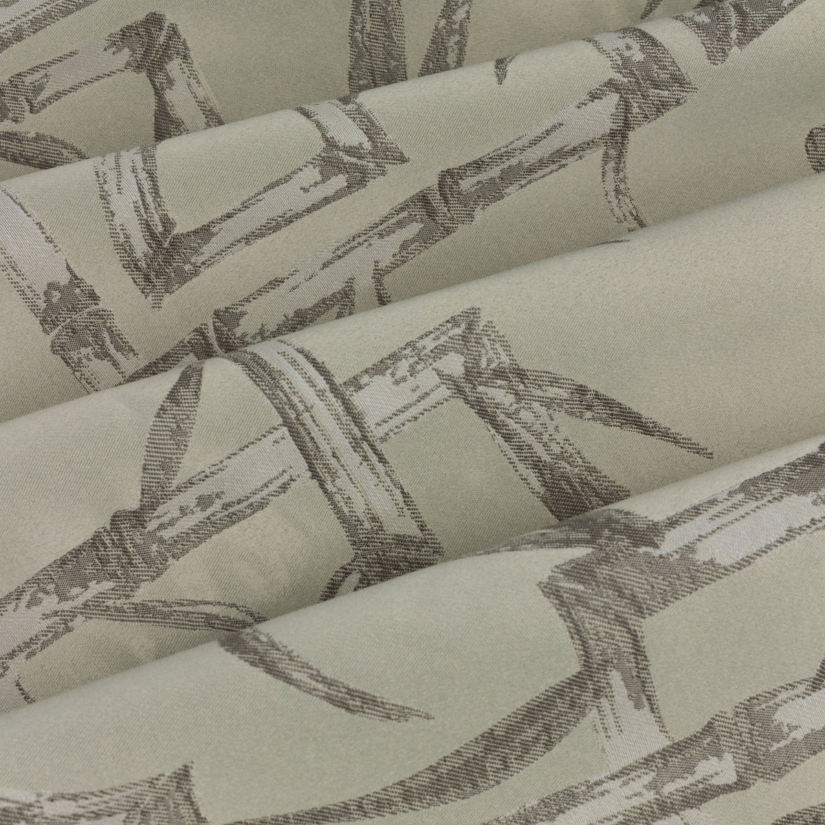 Close-up of Bamboo Jacquard Lined Eyelet Curtains in champagne, showing folded fabric with a woven grey bamboo cane and leaf pattern on a cream ground.
