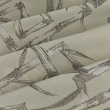 Close-up of Bamboo Jacquard Lined Eyelet Curtains in champagne, showing folded fabric with a woven grey bamboo cane and leaf pattern on a cream ground.