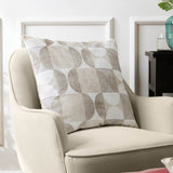 Bardot Geometric Velvet Cushion in Natural, 50 x 50cm square cushion with cut-velvet circle and half-circle pattern in beige, oatmeal and stone grey, shown on a cream armchair.