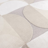 Close-up of the Bardot Geometric Velvet Cushion in Natural, showing cut-velvet circles and half-circles in beige, oatmeal and stone grey with a textured woven backing.