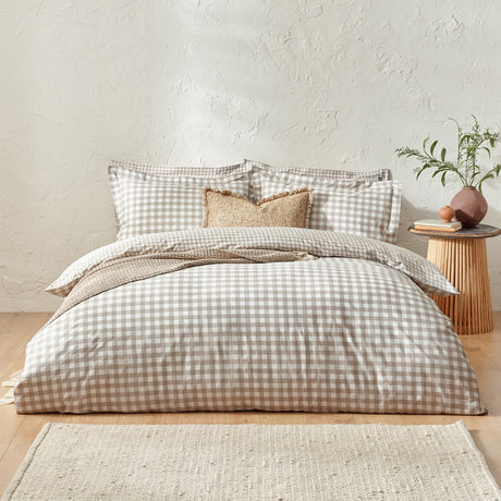 Barton Cotton Gingham Duvet Cover Set in natural beige and white check, styled on a bed with matching pillowcases and textured cushions in a bedroom setting.