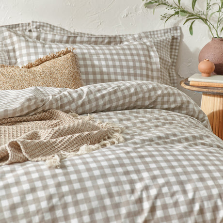 Barton Cotton Gingham Duvet Cover Set in Natural on a bedroom bed, showing beige-and-white check cotton bedding with matching pillowcases and a textured throw.