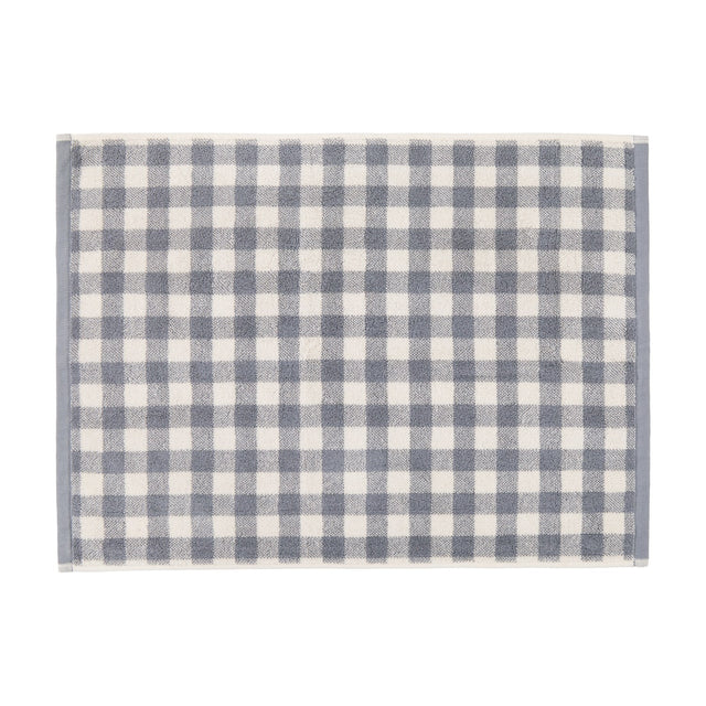 Barton Gingham Cotton Bath Mat in denim blue and cream check with plain woven border, shown flat on a white background.