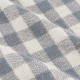 Close-up of Barton Gingham Cotton Towels in denim blue, showing the woven check pattern and looped terry texture of the cotton fabric.