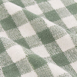 Close-up of the Barton Gingham Cotton Towel in Forest, showing a woven green and off-white check pattern with a textured terry cotton surface.