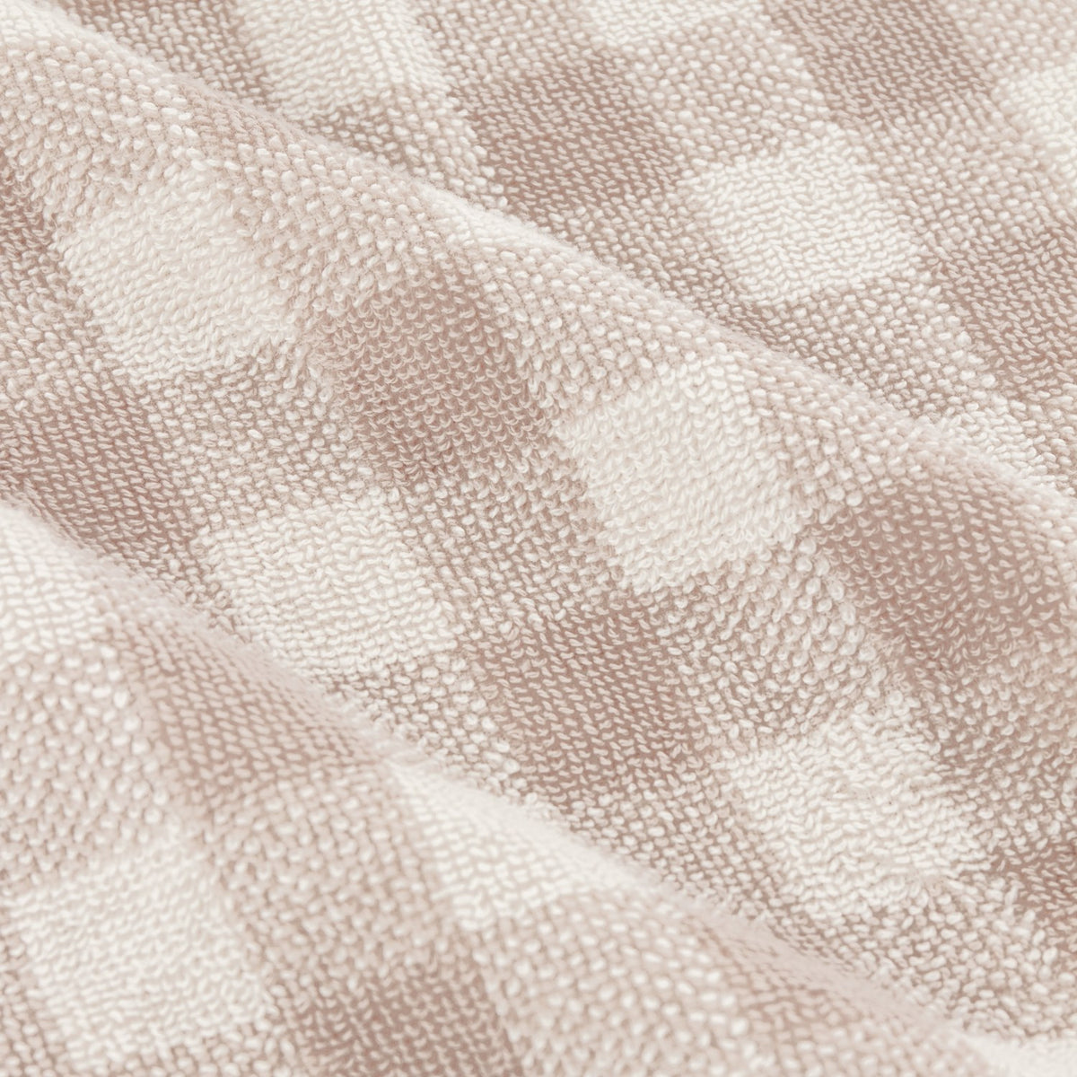 Close-up of the Barton Check Gingham Cotton Towels in natural and cream, showing a woven checked pattern in soft terry cotton fabric.