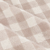 Close-up of the Barton Check Gingham Cotton Towels in natural and cream, showing a woven checked pattern in soft terry cotton fabric.