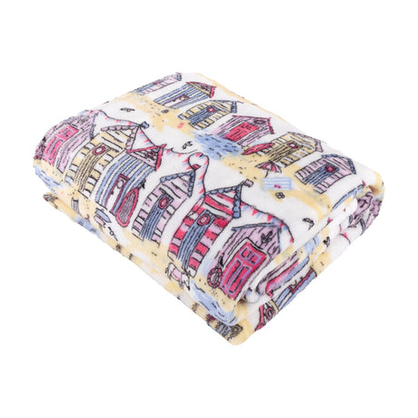 Folded Beach Huts Printed Polyester Throw in multicoloured coastal design, showing pink, blue, yellow and lilac beach hut illustrations on cream fleece fabric, shot on a white background.