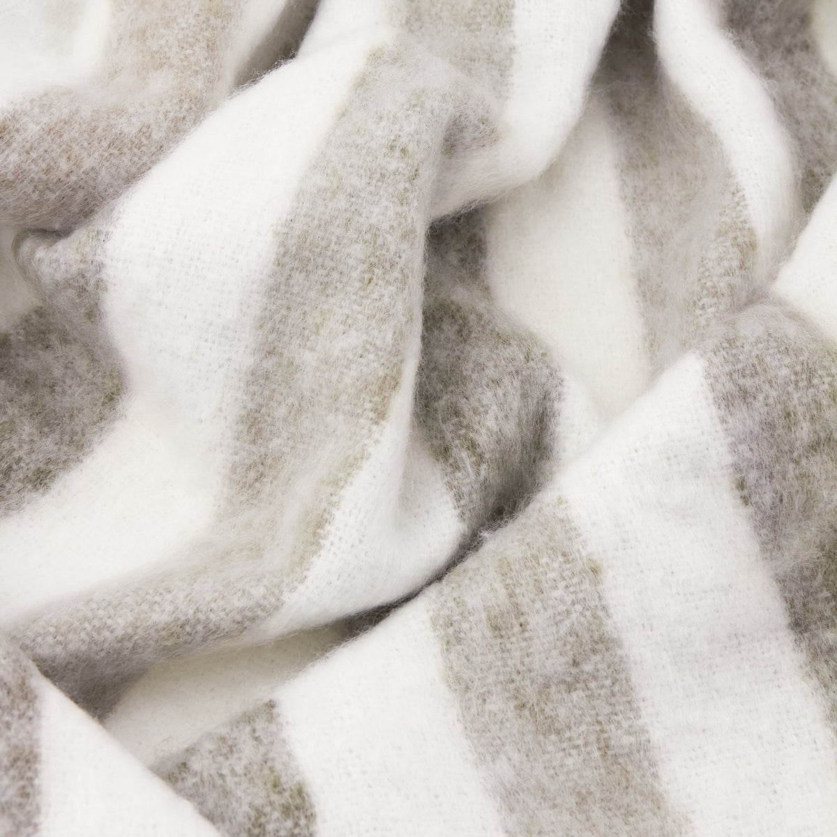 Beechwood Striped Cotton Throw in Heath, a woven off-white throw with broad grey stripes, shown draped in soft folds showing the textured fabric.