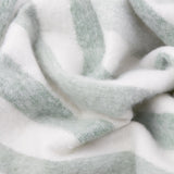 Close-up of the Beechwood Striped Cotton Throw in Moorland Green, showing its brushed, fringed cotton texture with soft sage green and off-white vertical stripes.