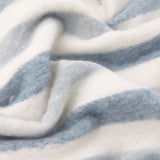 Close-up of the Beechwood Striped Polyester Throw in sky blue and cream, showing soft woven fabric folds in a heathered stripe pattern.
