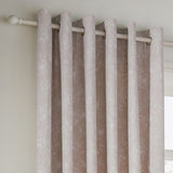 Bella Cotton Fully Lined Eyelet Curtains in natural, showing metal eyelet rings on a wooden pole with a fine white floral outline print on a soft cotton ground.