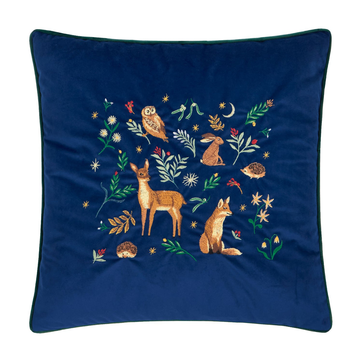 Berry Woods square navy velvet cushion with embroidered woodland scene of owl, hare, deer, fox and hedgehogs among leaves, berries and stars, dark green piped edge, on a white background.