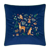 Berry Woods square navy velvet cushion with embroidered woodland scene of owl, hare, deer, fox and hedgehogs among leaves, berries and stars, dark green piped edge, on a white background.