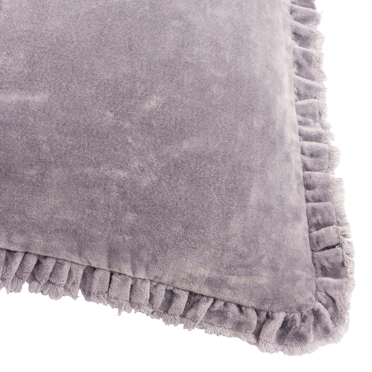 Close-up of the Bertie Velvet Cotton Cushion in mauve, showing plain cotton velvet fabric with a soft raised pile and a frayed fringe trim along the edge, on a white background.