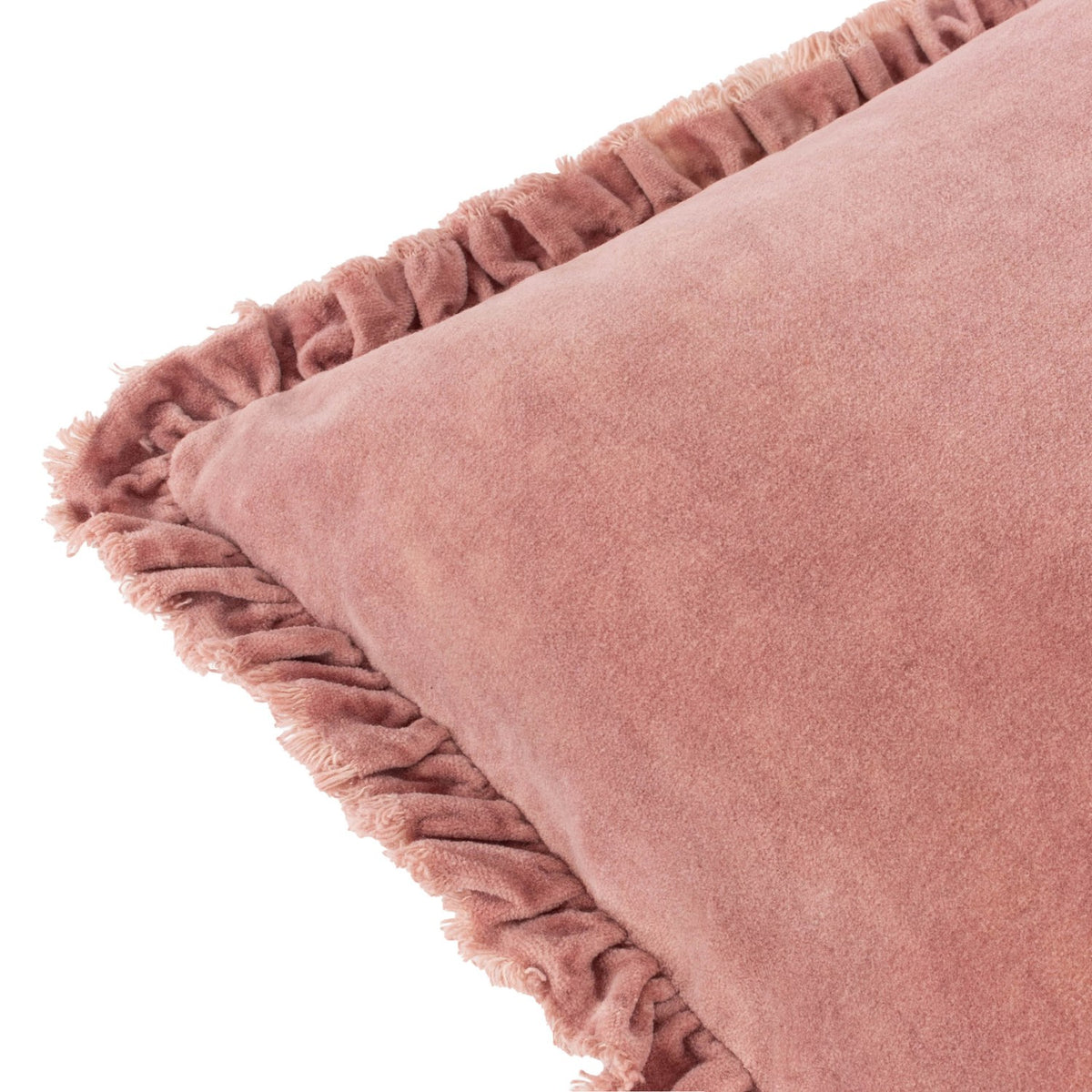 Close-up of the Bertie Velvet Cotton Cushion in rose pink, showing soft frayed ruffled edging and the velvet fabric's uneven, light-catching texture on a white background.
