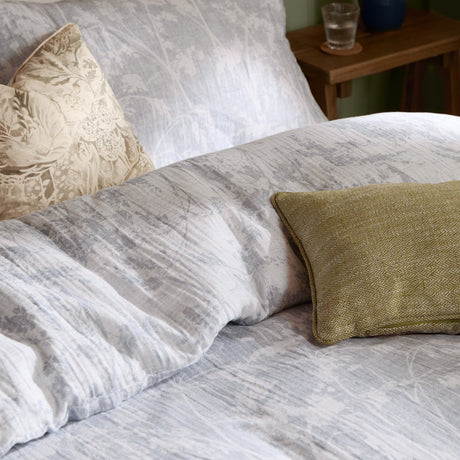 Braeflower Cotton Floral Duvet Cover Set in Chambray, grey botanic toile print with crinkled cotton texture, styled on a bed with cream and olive accent cushions.