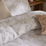 Braeflower Cotton Floral Duvet Cover Set in natural, showing crinkled cotton muslin with a soft meadow toile print, styled with linen and patterned cushions on a bed.