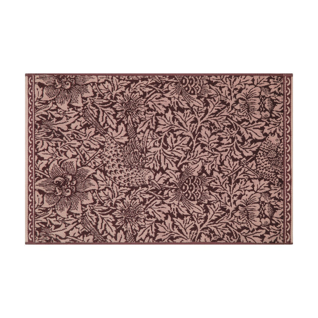 Rectangular cotton bath mat with Bird and Anemone floral pattern in two-tone plum, birds and leafy anemone motifs edge to edge, bordered trim, shown on a white background.
