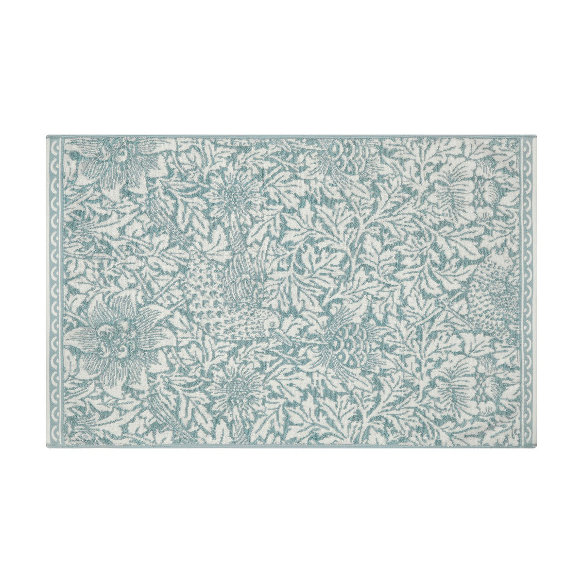 Rectangular Bird and Anemone cotton bath mat in slate blue floral print on cream, with a narrow scalloped border, shown on a plain white background.