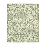 Folded Bird & Anemone jacquard cotton towel in sage green, showing a leafy foliage and bird pattern with a scalloped border, on a plain white background.