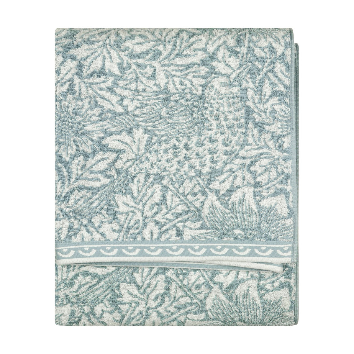 Folded Bird & Anemone jacquard cotton towel in slate blue with woven bird and foliage pattern and scalloped border trim, shown on a plain white background.