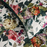 Bloom Cotton Floral Duvet Cover Set close-up showing pink, coral and cream painterly florals with green foliage on a cotton sateen fabric, edged with a solid dark green piping.