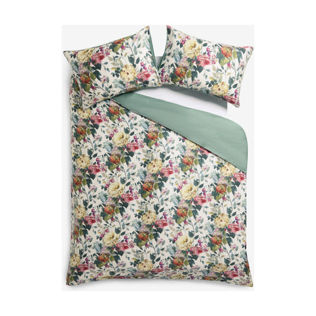 Bloom Cotton Floral Duvet Cover Set in cream with pink, coral and green painterly floral print, plain green reverse, shown with matching pillowcases on a white background.