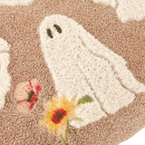 Close-up of the Bootanical Floral Velvet Cushion in natural beige, showing a tufted white ghost with embroidered face and red, yellow and pink floral embroidery in raised boucle texture.