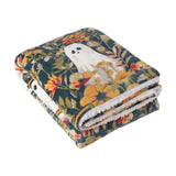 Folded Bootanical Floral polyester throw in deep teal with gold, rust and cream floral print and ghost motifs, sherpa fleece reverse visible, on a plain white background.