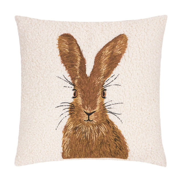 Square cushion in natural cream boucle fabric with an embroidered brown hare face, ears and whiskers at centre, shown on a plain white background.