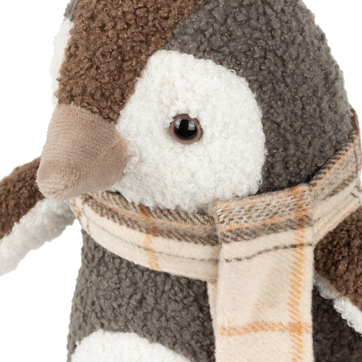 Close-up of the Boucle Penguin Animal Velvet Door Stop in warm grey, showing textured boucle fur, brown cap, cream face with dark eye, velvet beak, and a tartan scarf.