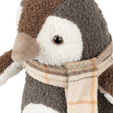 Close-up of the Boucle Penguin Animal Velvet Door Stop in warm grey, showing textured boucle fur, brown cap, cream face with dark eye, velvet beak, and a tartan scarf.