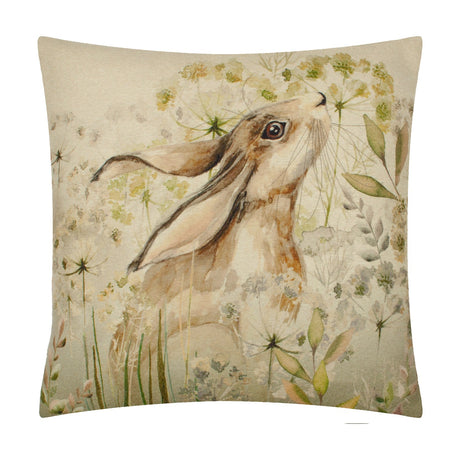 Bramble Hare square cushion in beige polyester fabric, printed with a watercolour hare in profile among cow parsley and grasses, shown on a plain white background.